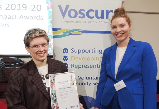 Rising Arts Agency staff collect their award at the Voscurs